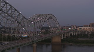 DX0002_181_046 - 5.7K aerial stock footage fly beside the Hernando de Soto Bridge at twilight toward Downtown Memphis, Tennessee