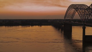 DX0002_181_048 - 5.7K aerial stock footage of the Hernando de Soto Bridge at sunset and the Arkansas side of the bridge