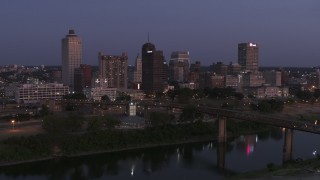 DX0002_182_001 - 5.7K aerial stock footage a stationary view across the river at the city's skyline at twilight in Downtown Memphis, Tennessee