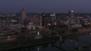 DX0002_182_007 - 5.7K aerial stock footage descend with a view of downtown from across the river at twilight in Downtown Memphis, Tennessee