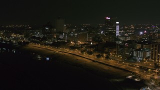 DX0002_182_017 - 5.7K aerial stock footage a reverse view of downtown office buildings at night, Downtown Memphis, Tennessee