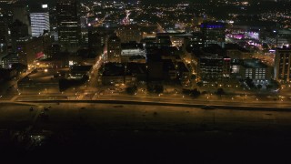 DX0002_182_027 - 5.7K aerial stock footage orbit office buildings and Riverside Drive at night in Downtown Memphis, Tennessee