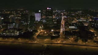 DX0002_182_028 - 5.7K aerial stock footage wide orbit of the One Commerce Square office tower at night in Downtown Memphis, Tennessee