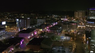 DX0002_182_042 - 5.7K aerial stock footage approach Beale Street and BB King Boulevard intersection at night in Downtown Memphis, Tennessee