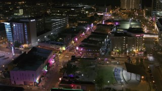 DX0002_182_043 - 5.7K aerial stock footage a view of Beale Street and BB King Boulevard intersection at night in Downtown Memphis, Tennessee