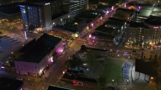 DX0002_182_045 - 5.7K stock footage aerial video fly toward Beale Street and BB King Boulevard intersection at night in Downtown Memphis, Tennessee