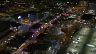 DX0002_182_047 - 5.7K aerial stock footage of flying away from intersection of Beale Street and BB King Boulevard at night in Downtown Memphis, Tennessee