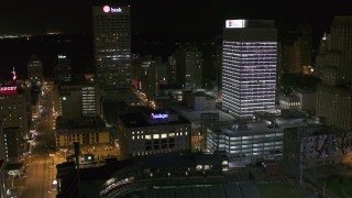 DX0002_182_052 - 5.7K aerial stock footage flyby One Commerce Square and First Tennessee Building at night, reveal Monroe Avenue, Downtown Memphis, Tennessee