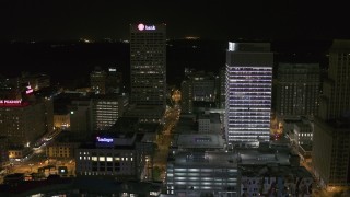 DX0002_182_053 - 5.7K aerial stock footage of One Commerce Square and First Tennessee Building at night by Monroe Avenue, Downtown Memphis, Tennessee