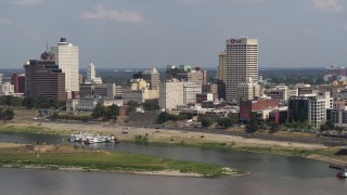 DX0002_183_023 - 5.7K aerial stock footage of One Commerce Square towering over city buildings, Downtown Memphis, Tennessee