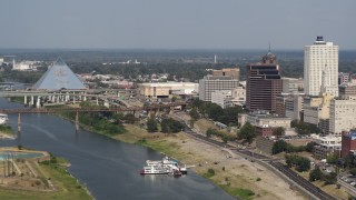 DX0002_183_030 - 5.7K aerial stock footage of Wolf River Harbor and a bridge between pyramid and office towers, Downtown Memphis, Tennessee