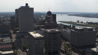 DX0002_184_012 - 5.7K aerial stock footage of office high-rise behind a county building and police station in Downtown Memphis, Tennessee