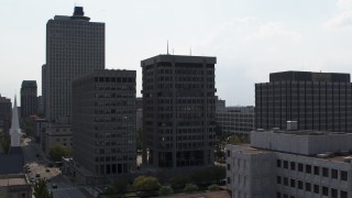 DX0002_184_015 - 5.7K aerial stock footage descend by a county building and police station in Downtown Memphis, Tennessee