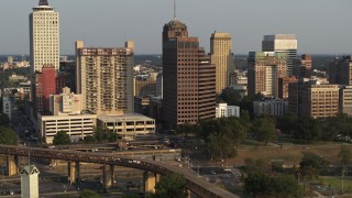 DX0002_185_036 - 5.7K aerial stock footage of orbiting an apartment complex and office high-rise at sunset, Downtown Memphis, Tennessee