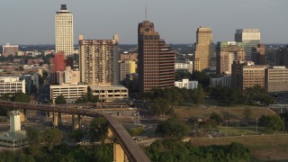 DX0002_185_038 - 5.7K aerial stock footage of an orbit of an apartment complex and office tower at sunset, Downtown Memphis, Tennessee