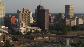 DX0002_185_039 - 5.7K aerial stock footage of circling an apartment complex and office tower at sunset, Downtown Memphis, Tennessee