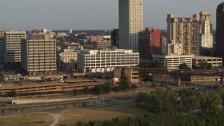 DX0002_185_042 - 5.7K aerial stock footage focus on Memphis City Hall during descent at sunset, Downtown Memphis, Tennessee