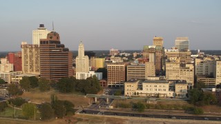DX0002_186_009 - 5.7K aerial stock footage orbit Raymond James Tower and city buildings at sunset, Downtown Memphis, Tennessee