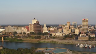 DX0002_186_010 - 5.7K aerial stock footage fly away from Raymond James Tower for wider view of skyline at sunset, Downtown Memphis, Tennessee