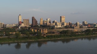 DX0002_186_015 - 5.7K aerial stock footage orbit and approach museum at sunset, skyline in distance, Downtown Memphis, Tennessee