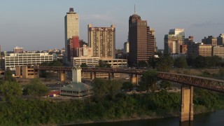 DX0002_186_017 - 5.7K aerial stock footage orbit welcome center, bridge, apartment complex and office tower at sunset, Downtown Memphis, Tennessee