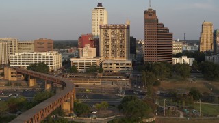 DX0002_186_018 - 5.7K aerial stock footage orbit apartment complex and neighboring office tower at sunset, Downtown Memphis, Tennessee