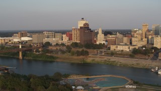 DX0002_186_022 - 5.7K aerial stock footage orbit apartment and office towers across river at sunset, Downtown Memphis, Tennessee