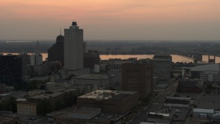 DX0002_186_038 - 5.7K aerial stock footage flyby and away from office towers at sunset, with view of river, Downtown Memphis, Tennessee