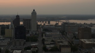 DX0002_186_039 - 5.7K aerial stock footage orbit office towers at sunset, with view of river and bridge, Downtown Memphis, Tennessee