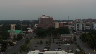 DX0002_186_045 - 5.7K aerial stock footage a view of a hospital at twilight during descent in Memphis, Tennessee