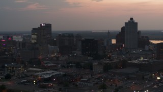 DX0002_187_003 - 5.7K aerial stock footage of a reverse view of the city's downtown skyline at twilight, Downtown Memphis, Tennessee