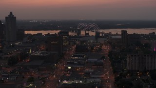 DX0002_187_008 - 5.7K aerial stock footage orbit Hernando de Soto Bridge, seen from Downtown Memphis, Tennessee at twilight