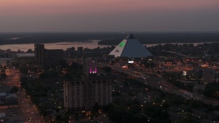 DX0002_187_012 - 5.7K aerial stock footage a stationary view of the Memphis Pyramid at twilight, Downtown Memphis, Tennessee