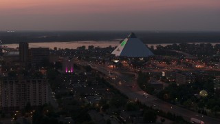 DX0002_187_013 - 5.7K aerial stock footage of orbiting the Memphis Pyramid at twilight, Downtown Memphis, Tennessee