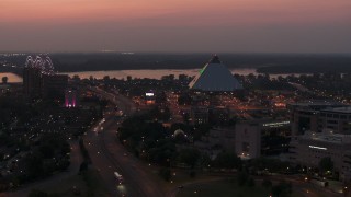 DX0002_187_014 - 5.7K aerial stock footage an orbit of the Memphis Pyramid at twilight, Downtown Memphis, Tennessee