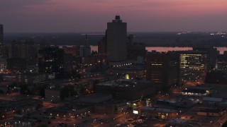 DX0002_187_017 - 5.7K aerial stock footage of the 100 North Main office tower at twilight, Downtown Memphis, Tennessee