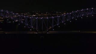 DX0002_187_031 - 5.7K aerial stock footage of an orbit of the bridge with purple lights at night, Memphis, Tennessee