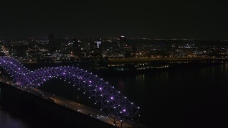 DX0002_187_037 - 5.7K aerial stock footage ascend past the bridge with purple lights for a view of the skyline at night, Downtown Memphis, Tennessee