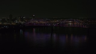 DX0002_187_045 - 5.7K aerial stock footage static view of the skyline and the bridge with colorful lights at night, Downtown Memphis, Tennessee