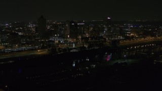 DX0002_187_053 - 5.7K aerial stock footage of passing lights on the bridge at night to reveal Downtown Memphis, Tennessee