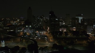 DX0002_187_056 - 5.7K aerial stock footage orbit apartment and office high-rises at night, Downtown Memphis, Tennessee