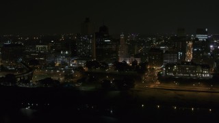 DX0002_187_057 - 5.7K aerial stock footage of orbiting apartment and office high-rises at night, Downtown Memphis, Tennessee