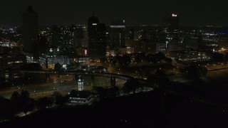 DX0002_187_060 - 5.7K aerial stock footage approach and orbit the city's downtown skyline at night, Downtown Memphis, Tennessee