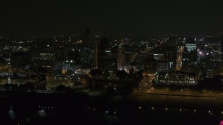 DX0002_187_062 - 5.7K aerial stock footage orbit office tower and downtown skyline at night, Downtown Memphis, Tennessee