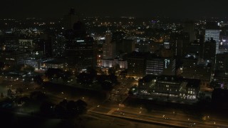 DX0002_187_067 - 5.7K aerial stock footage orbiting office high-rise and downtown buildings at night, Downtown Memphis, Tennessee