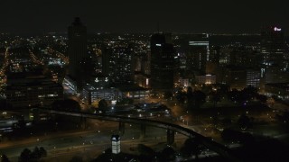DX0002_187_071 - 5.7K aerial stock footage of ascending toward the city's downtown skyline at nighttime, Downtown Memphis, Tennessee