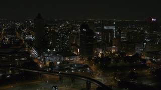 DX0002_187_072 - 5.7K aerial stock footage fly away from high-rises for wider view of the city's skyline at nighttime, Downtown Memphis, Tennessee