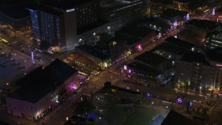DX0002_188_003 - 5.7K aerial stock footage approach and fly away from Beale Street intersection at nighttime, Downtown Memphis, Tennessee