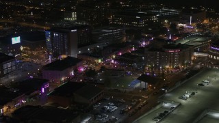 DX0002_188_010 - 5.7K aerial stock footage of circling a Beale Street intersection at nighttime, Downtown Memphis, Tennessee