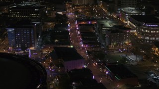 DX0002_188_011 - 5.7K aerial stock footage of colorful lights and signs on Beale Street at nighttime, Downtown Memphis, Tennessee